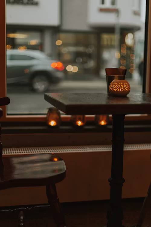Cosy café corner details with warm light, texture, and lived-in community energy
